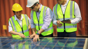 Three energy management personnel attend to a microgrid in New England.