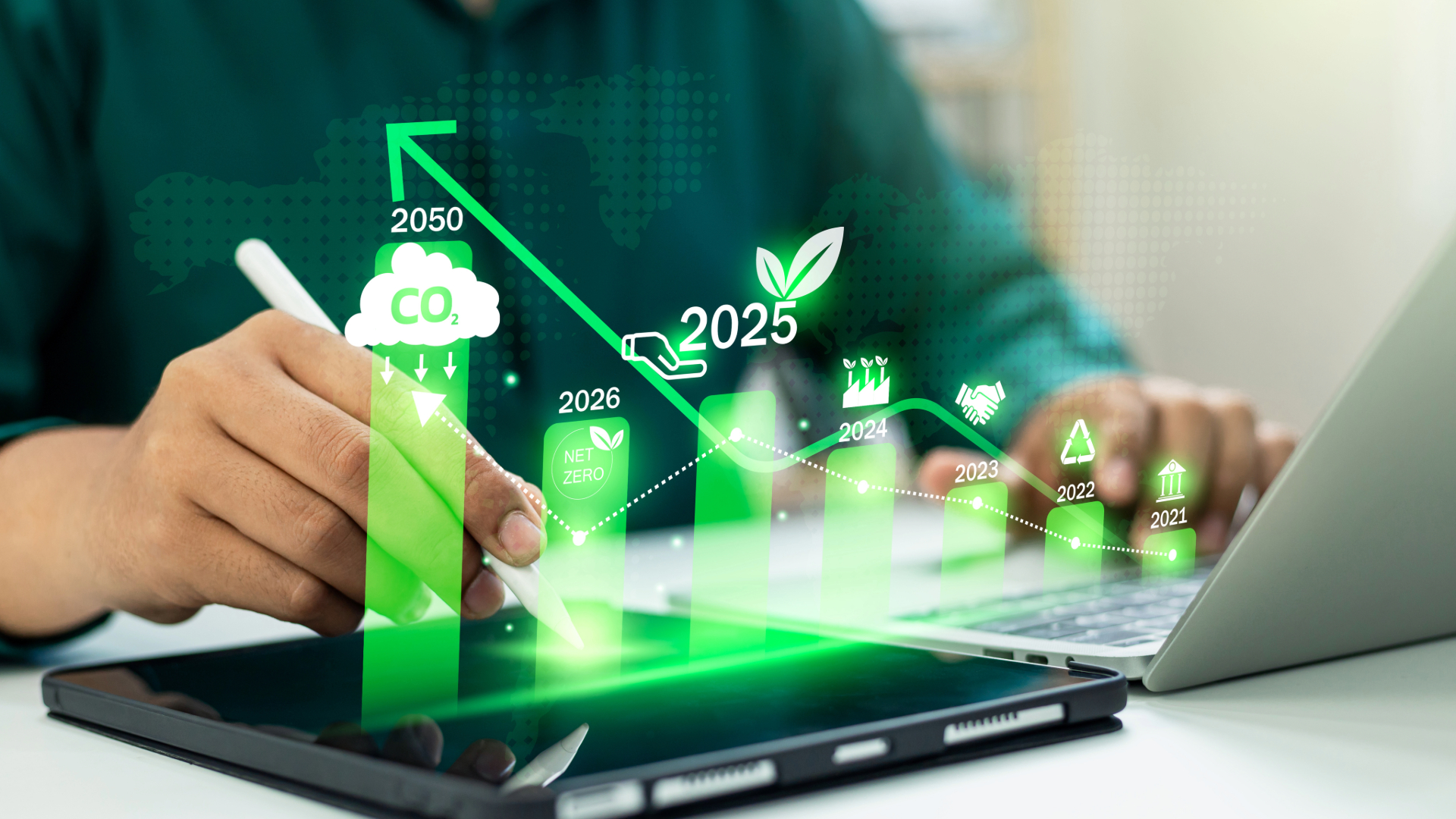 A man sits at his computer evaluating a renewable energy chart outlining energy savigs for businesses.