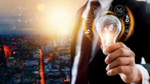 A man in a business suit holds a light bulb, with a smart energy procurement supply chain in the background.