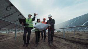 A renewable energy procurement specialist guides business owners through solar panels.